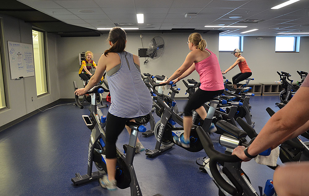 people working out on spinning bikes